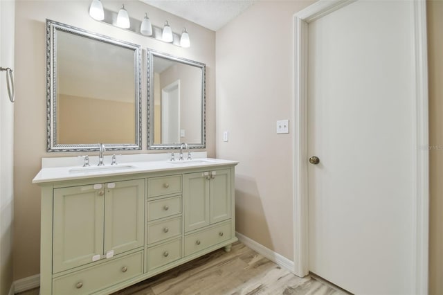 bathroom with vanity, a textured ceiling, and hardwood / wood-style flooring