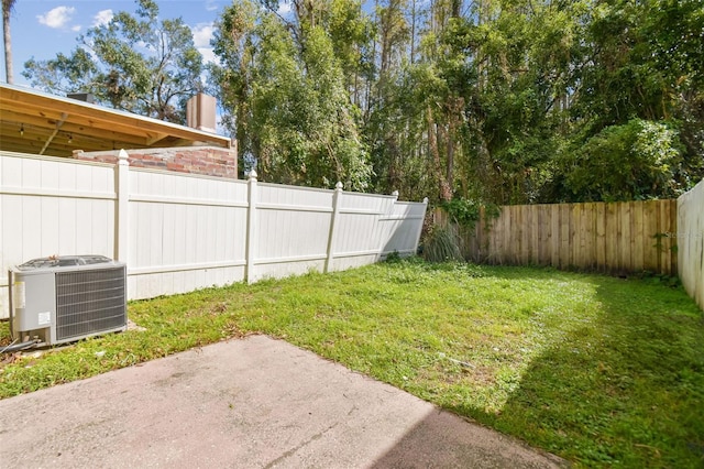 view of yard with central AC unit and a patio area