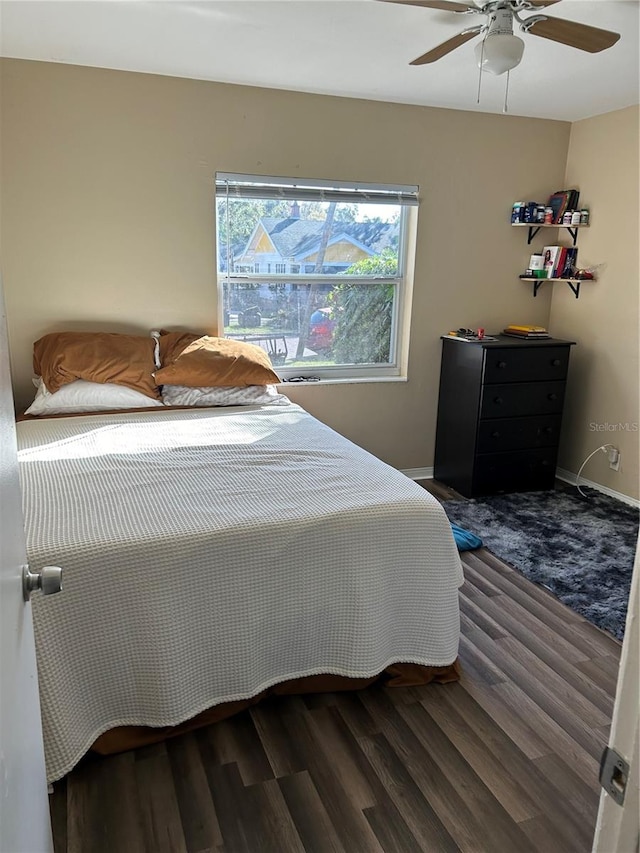 bedroom featuring ceiling fan and dark hardwood / wood-style floors