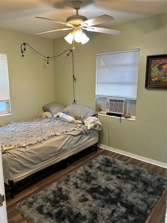 bedroom featuring hardwood / wood-style floors, cooling unit, and ceiling fan