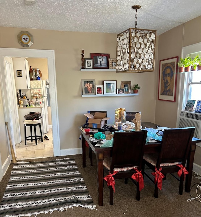 carpeted dining space featuring cooling unit and a textured ceiling