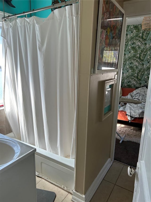 bathroom with vanity, shower / bath combo with shower curtain, and tile patterned floors