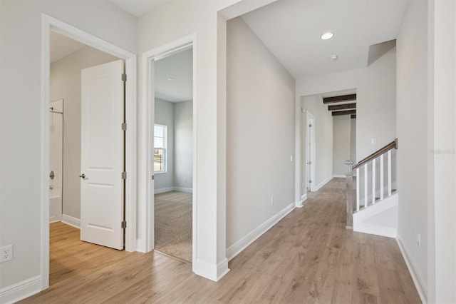 corridor with recessed lighting, light wood-style flooring, and baseboards