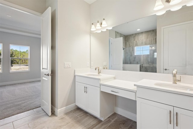 bathroom featuring a wealth of natural light, a sink, and a shower stall