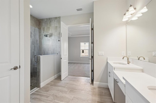 bathroom with a stall shower, visible vents, vanity, and baseboards