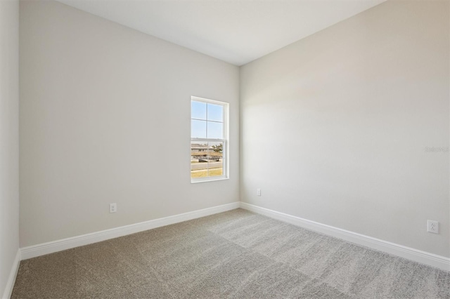 spare room with carpet and baseboards