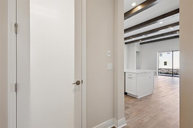 corridor with baseboards, beamed ceiling, light wood-style flooring, and recessed lighting