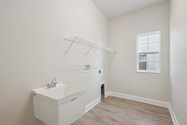 clothes washing area featuring washer hookup, light wood finished floors, electric dryer hookup, laundry area, and baseboards