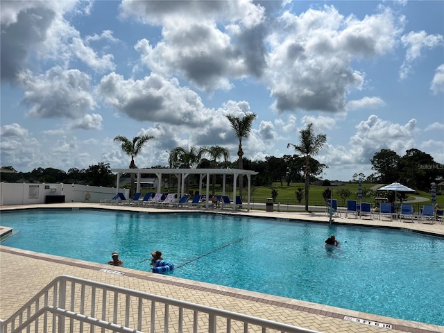 community pool featuring a patio, fence, and a pergola