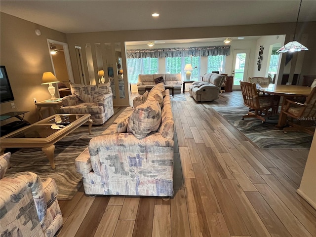 living room featuring ceiling fan and wood finished floors