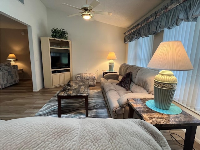 living room featuring hardwood / wood-style flooring, ceiling fan, and lofted ceiling