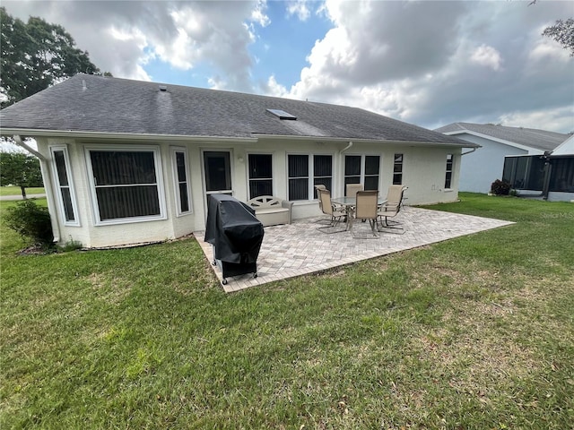 back of property featuring a yard and a patio