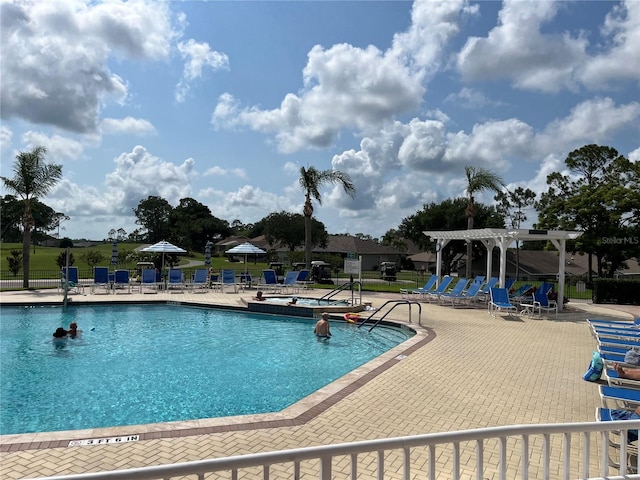 view of swimming pool featuring a pergola and a patio area