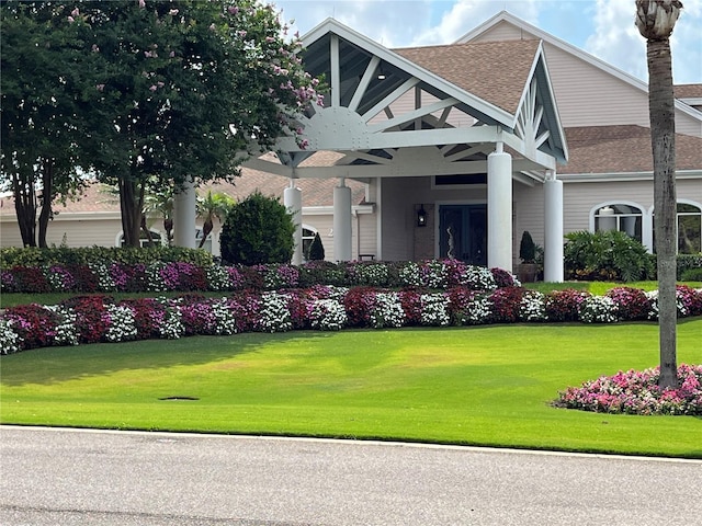 view of front of house featuring a front yard and french doors