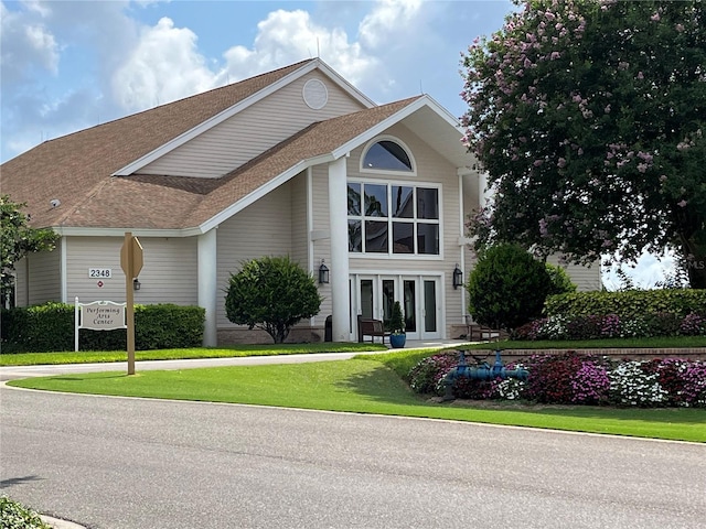 view of front of house featuring french doors and a front yard