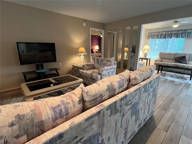 living room with ceiling fan and light wood-type flooring