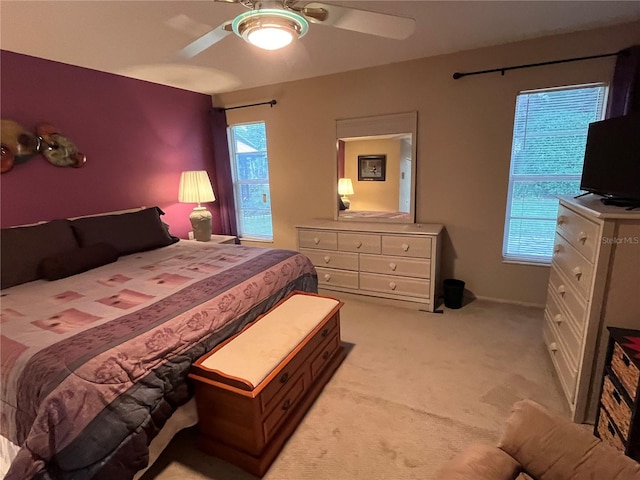 bedroom featuring light colored carpet and ceiling fan