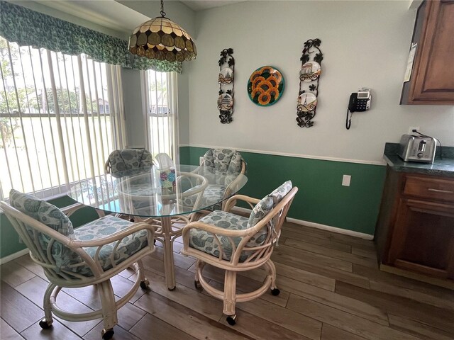 dining space with dark hardwood / wood-style flooring