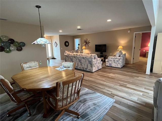 dining space with light hardwood / wood-style flooring