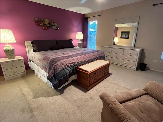 bedroom with ceiling fan and light colored carpet