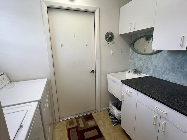 laundry room with light tile patterned flooring, cabinets, and separate washer and dryer