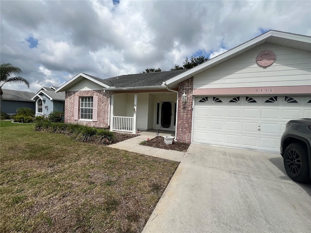 ranch-style home with a front lawn, covered porch, and a garage