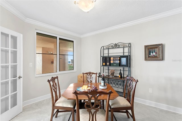 dining room featuring a textured ceiling and crown molding