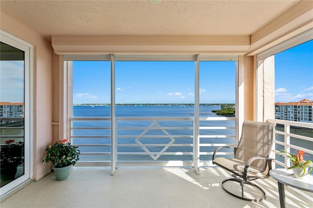 sunroom / solarium with a water view