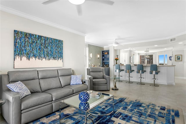 living room with ceiling fan and crown molding