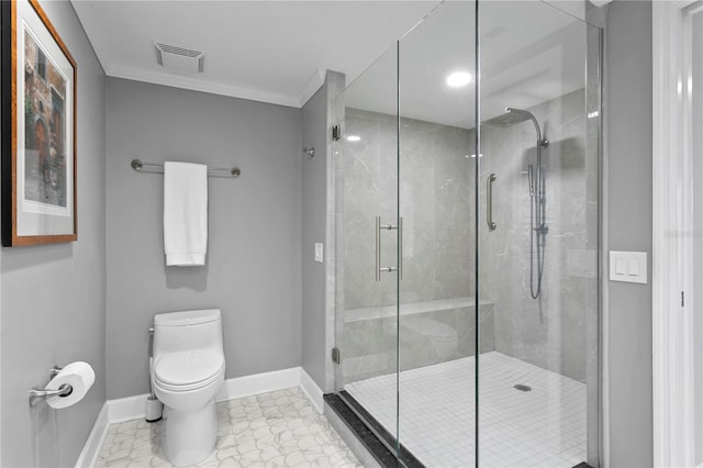 bathroom with toilet, crown molding, and a shower with shower door