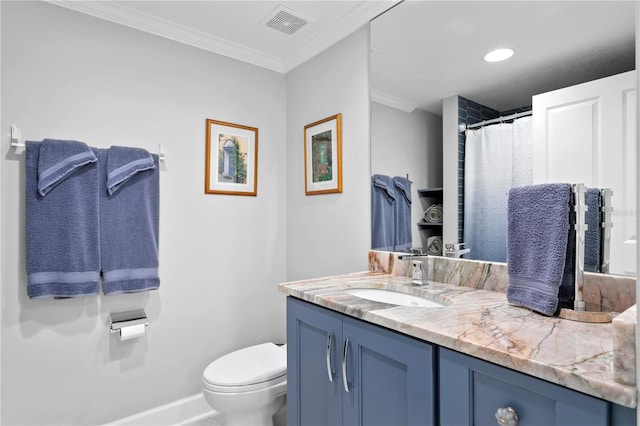 bathroom featuring vanity, toilet, and crown molding