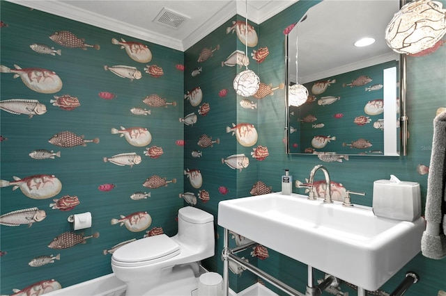 bathroom featuring toilet and crown molding