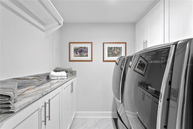 laundry area featuring cabinets and washer and dryer