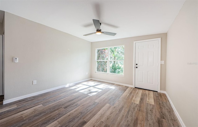 empty room with ceiling fan and dark hardwood / wood-style floors