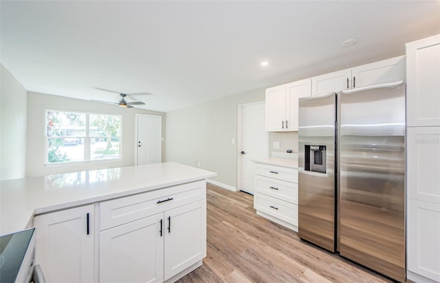 kitchen with ceiling fan, stainless steel fridge with ice dispenser, light hardwood / wood-style floors, and white cabinets