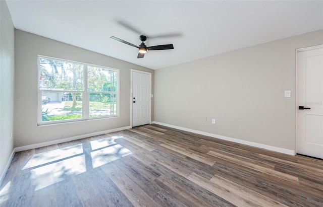 unfurnished room with ceiling fan and wood-type flooring