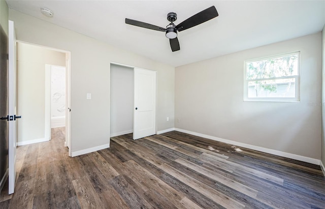 unfurnished bedroom with ceiling fan, dark hardwood / wood-style floors, and a closet