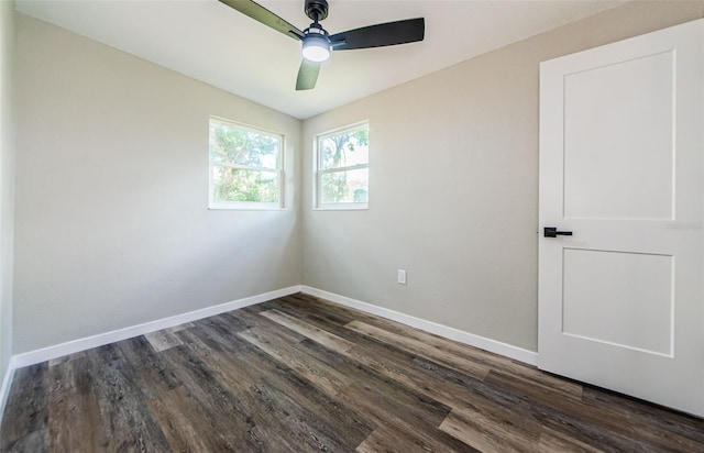 spare room with dark hardwood / wood-style flooring and ceiling fan