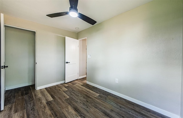 unfurnished bedroom featuring ceiling fan, dark hardwood / wood-style floors, and a closet