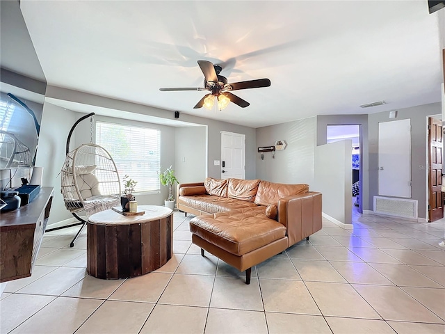 living room with ceiling fan and light tile patterned floors