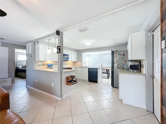 kitchen featuring kitchen peninsula, pendant lighting, appliances with stainless steel finishes, white cabinetry, and light tile patterned floors