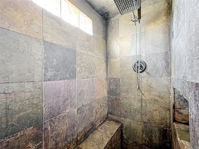 bathroom with a tile shower