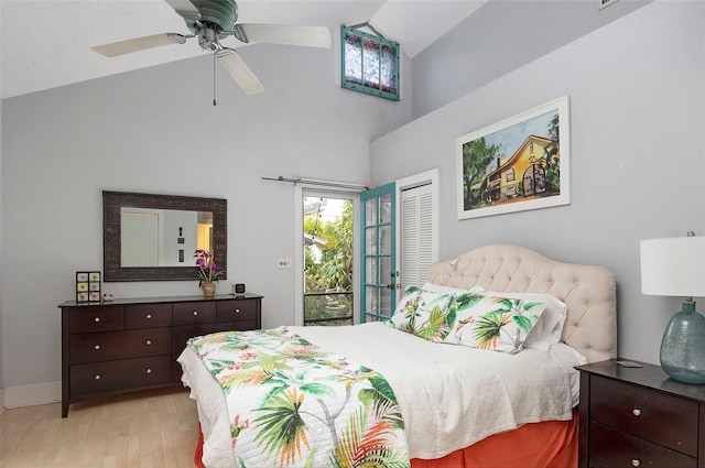 bedroom with a closet, light wood-type flooring, access to exterior, high vaulted ceiling, and ceiling fan