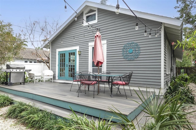 rear view of property featuring french doors and a wooden deck