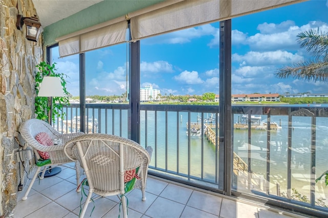 unfurnished sunroom featuring a water view