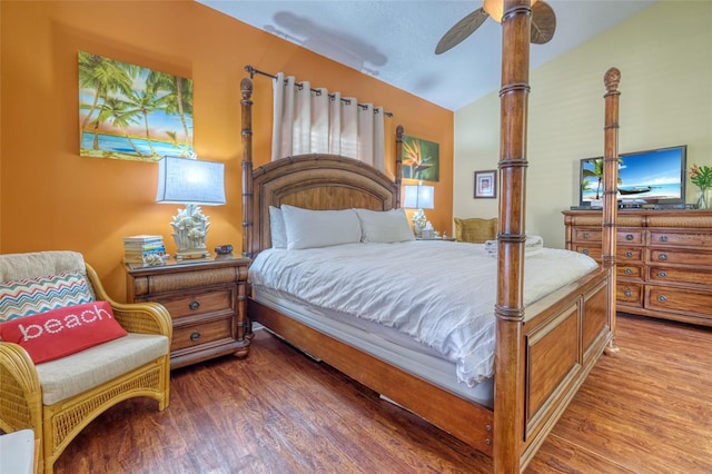 bedroom featuring wood-type flooring, ceiling fan, and vaulted ceiling