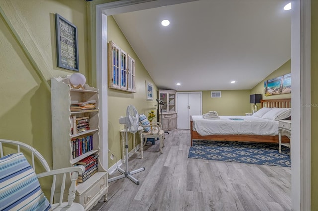 bedroom featuring light hardwood / wood-style flooring and vaulted ceiling