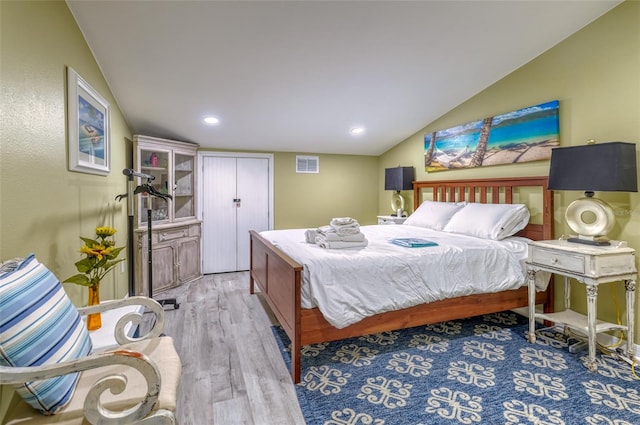 bedroom with light hardwood / wood-style floors and vaulted ceiling