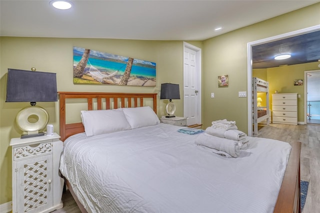 bedroom with light hardwood / wood-style floors and vaulted ceiling