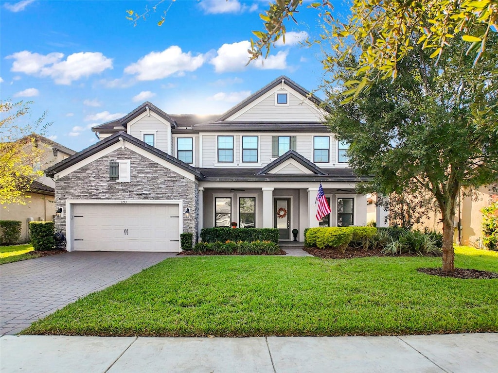 view of front of property with a garage and a front lawn